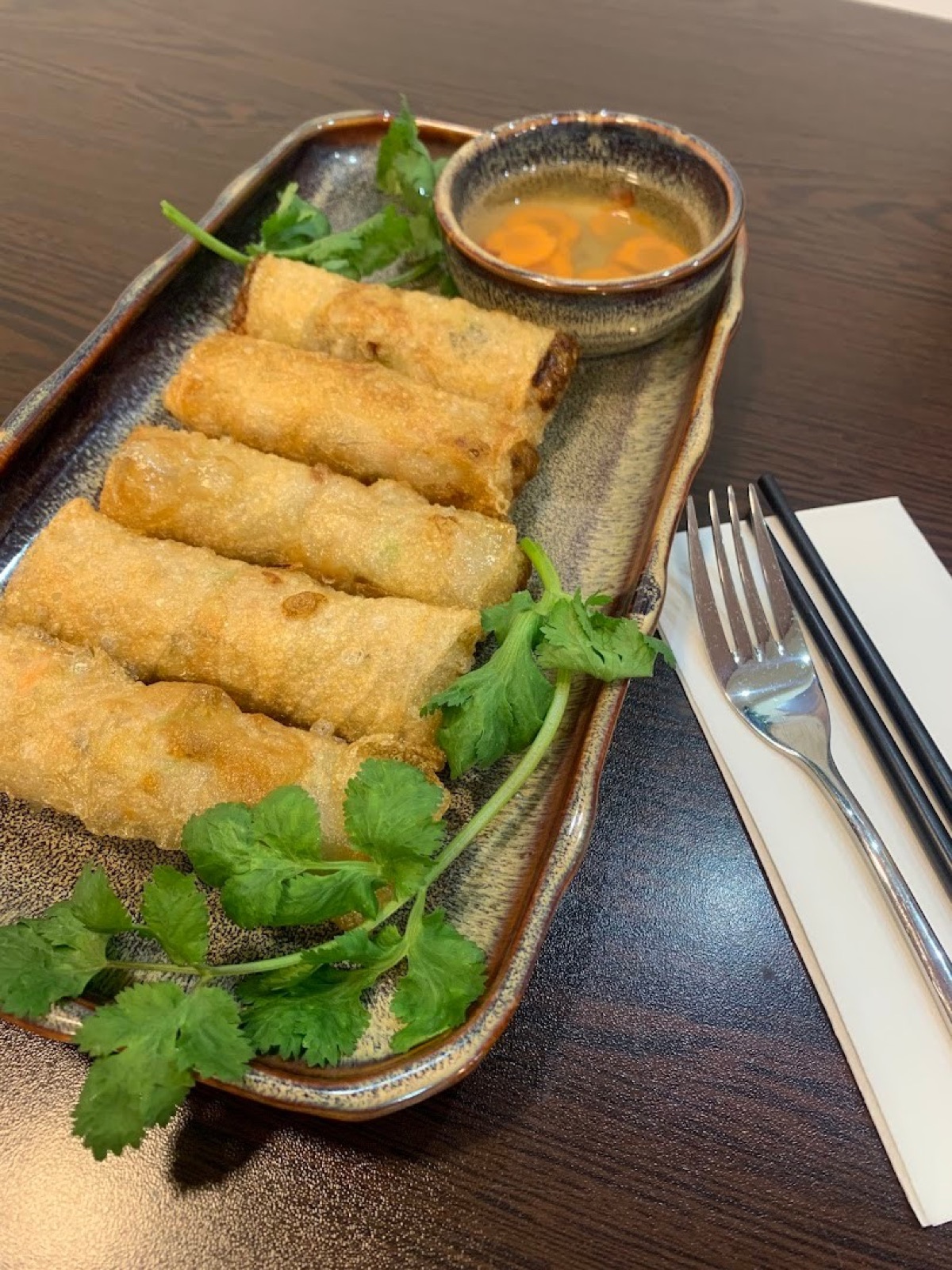 Original phone photo of spring rolls on a restaurant table