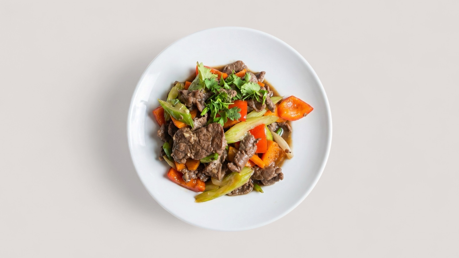 Splentify-enhanced beef stir fry in a white bowl