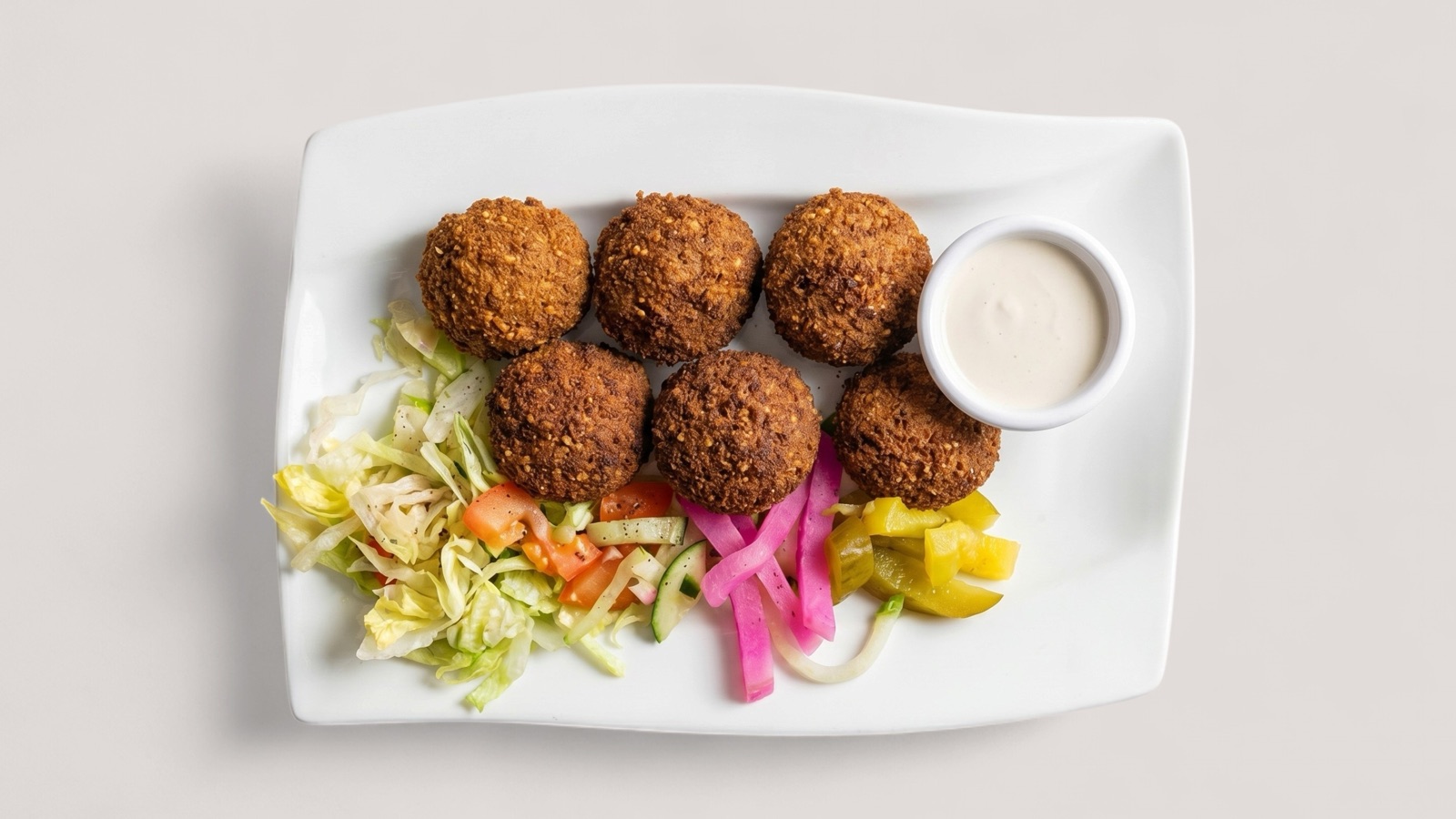 Splentify-enhanced falafel plate with sauce