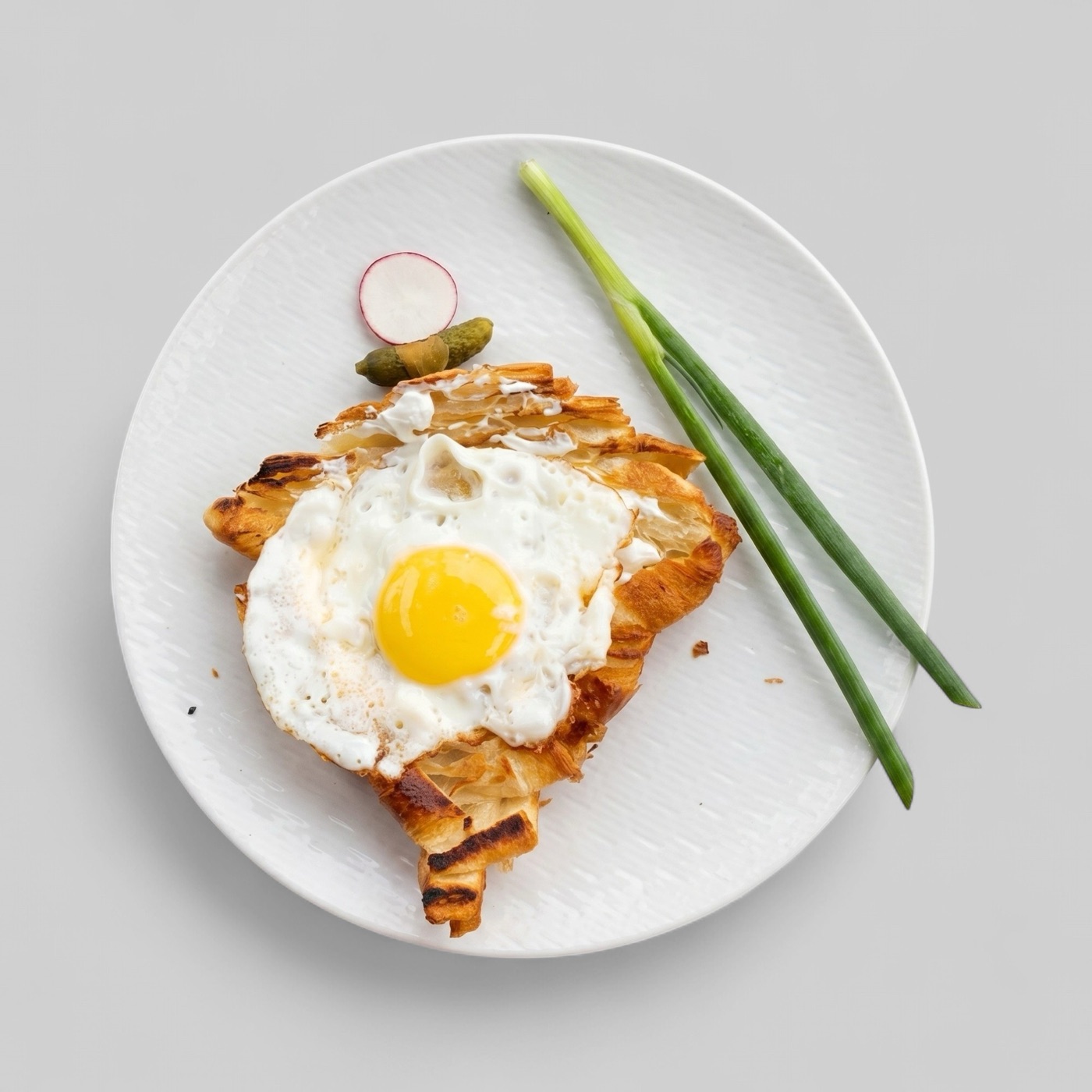 Splentify-enhanced croissant egg dish on a clean plate