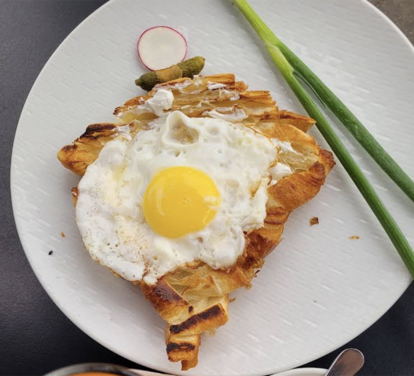 Original phone photo of a croissant egg dish